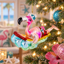 Pink Flamingo Riding a Surf Wave Glass Christmas Ornament