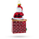 Santa Delivering Presents Down the Chimney Glass Christmas Ornament