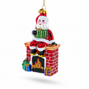 Santa Delivering Presents Down the Chimney Glass Christmas Ornament
