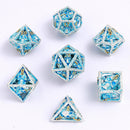 Skull's Grin Hollow Metal Dice Set - Glow in the Dark Blue