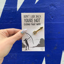 Don't Look Back Arrow Enamel Pin in Gold on Gift Card