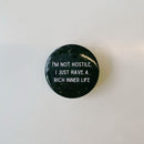 I'm Not Hostile I Just Have a Rich Inner Life 1.5" Button in Black and Tan