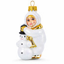 Toddler Hugging Snowman Glass Christmas Ornament