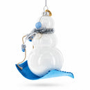 Snowman Riding a Sled Glass Christmas Ornament
