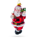 Santa Decorating the Train Blown Glass Christmas Ornament