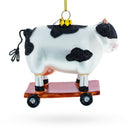 Spotted Cow Ice Skating Blown Glass Christmas Ornament